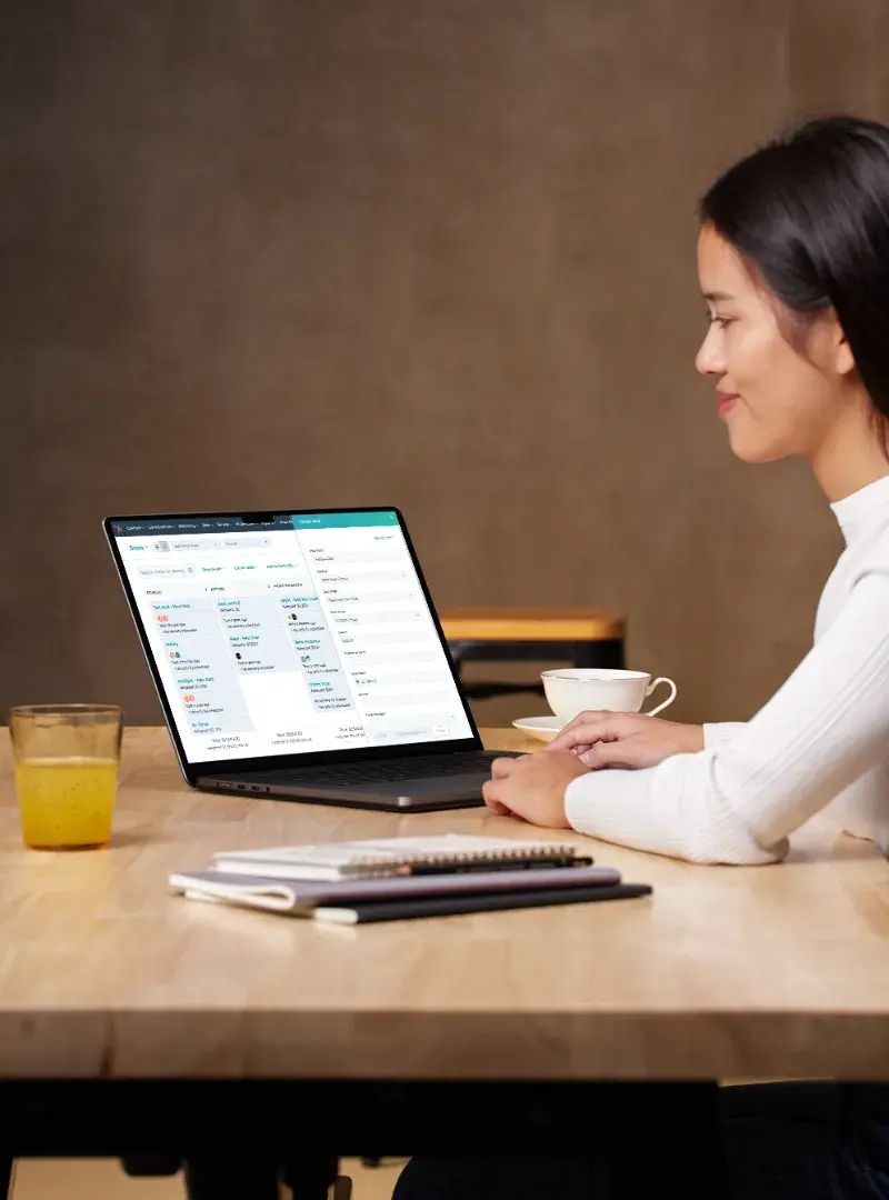 Person working on a laptop with a HubSpot automation workflow displayed.